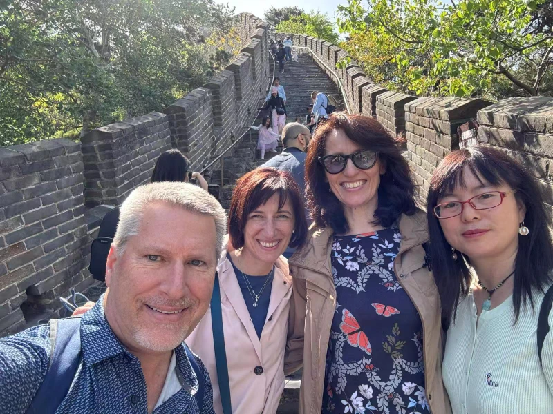 Beijing tour guide leading private group at the Great Wall of China